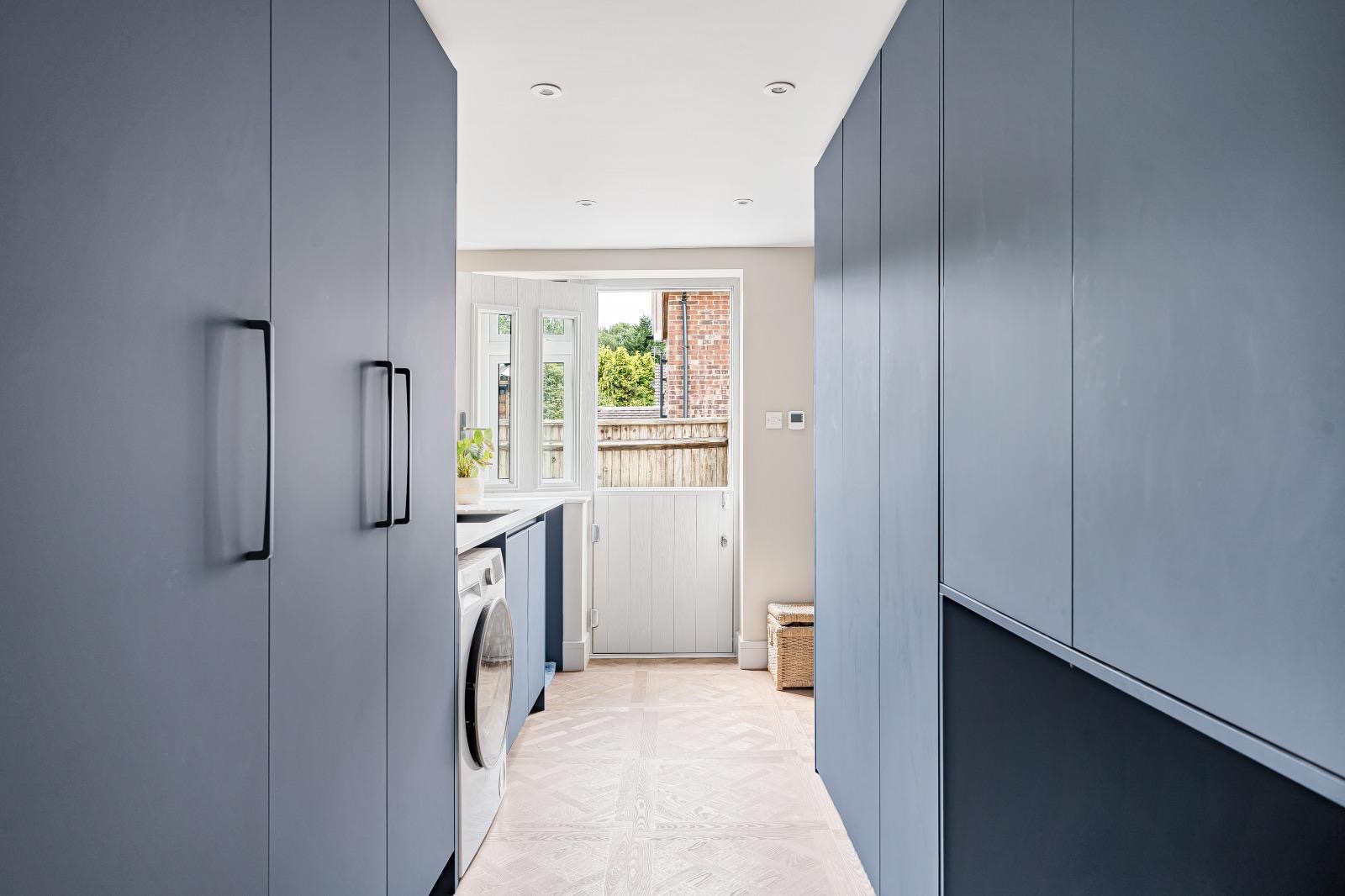 Versailles-style luxury vinyl flooring carried through the adjoining utility room