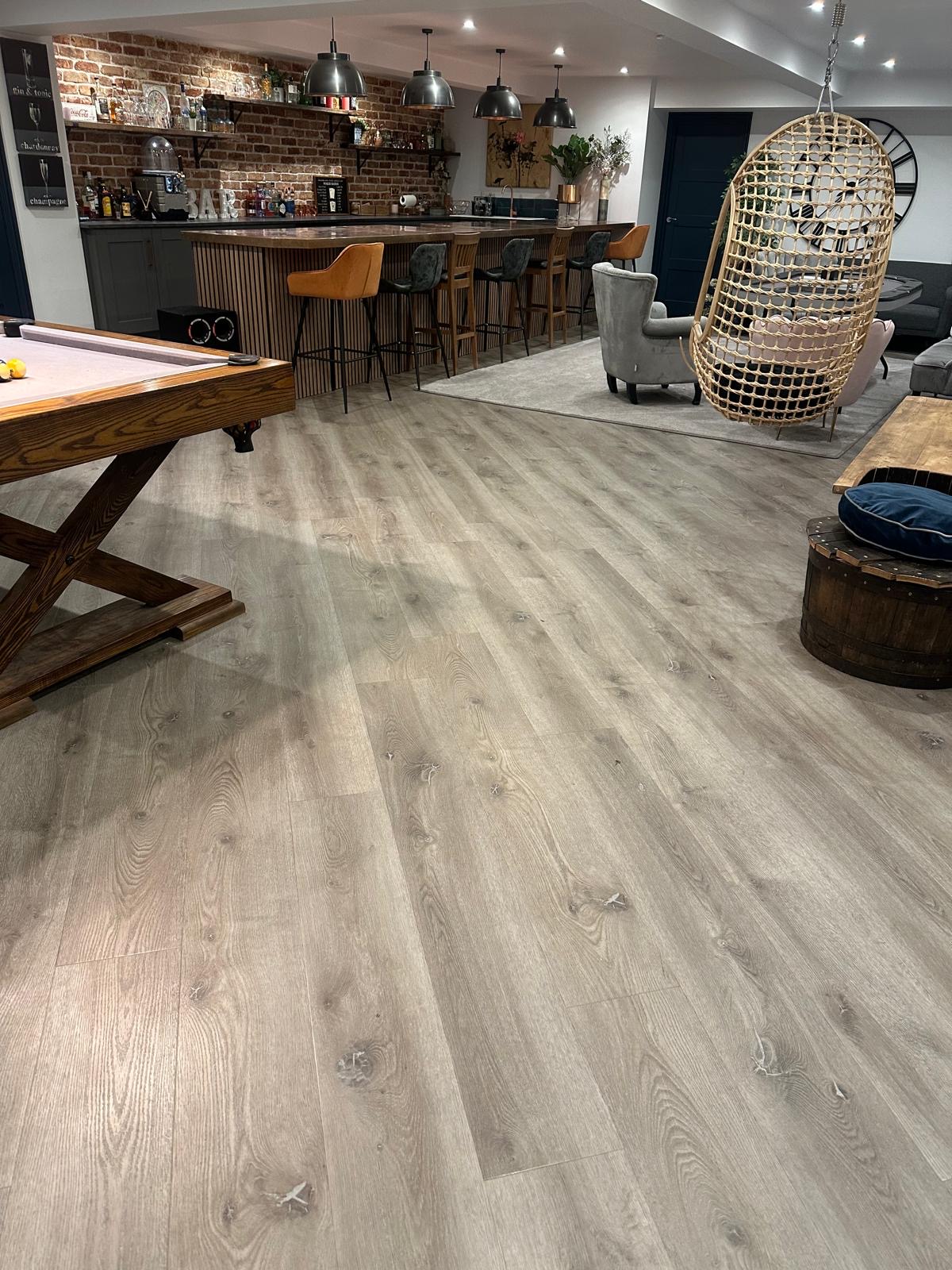 LVT flooring throughout a Guildford basement entertainment room and private bar