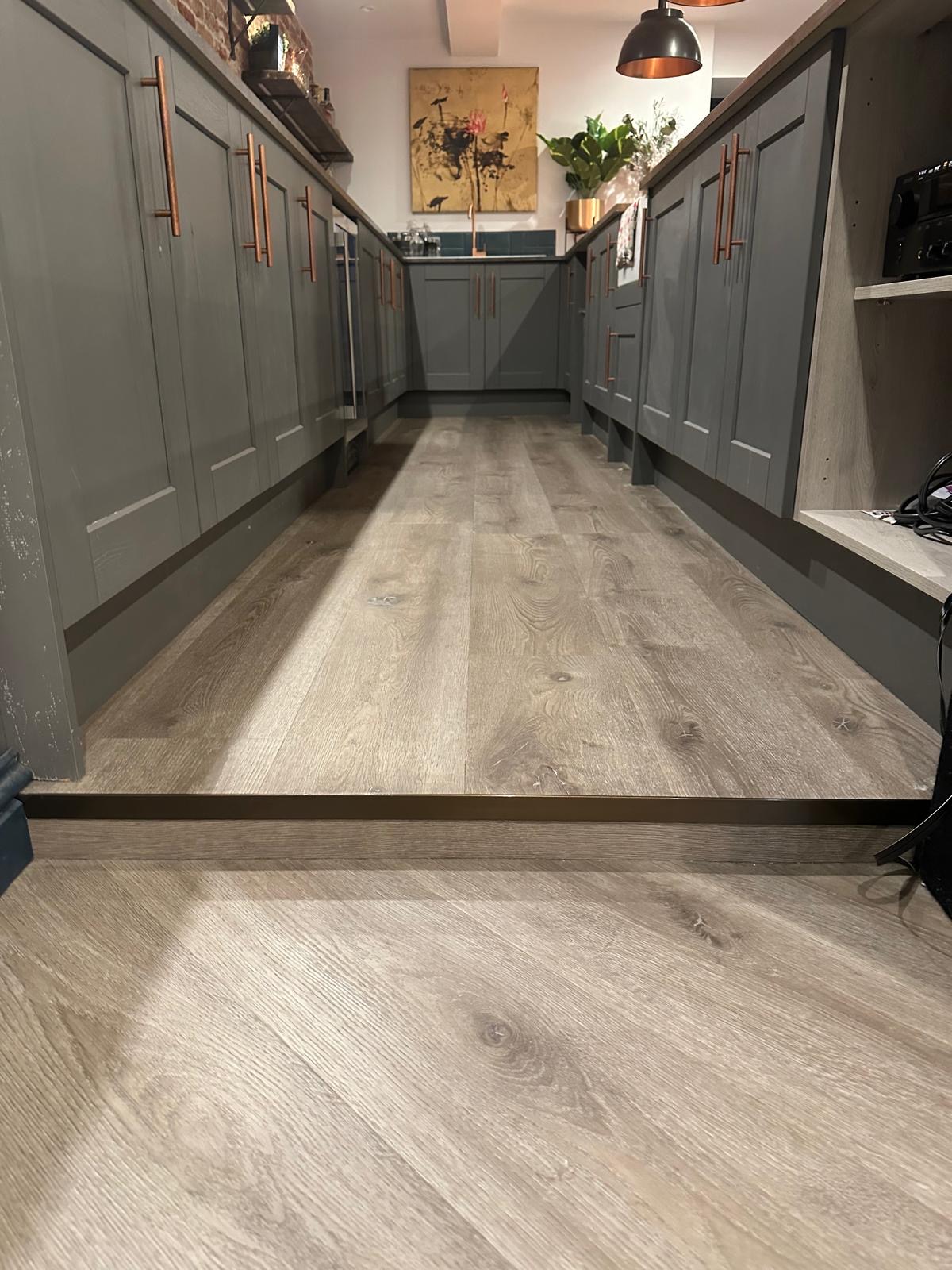 LVT flooring professionally installed beneath the Guildford basement bar cupboards