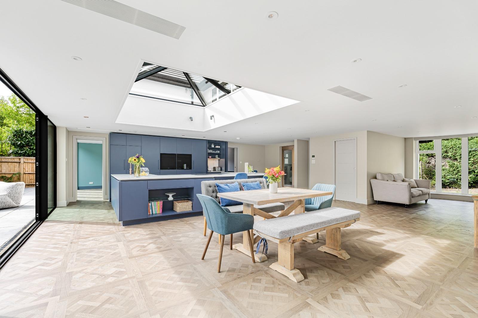 Geometric LVT floor flowing through a bright open-plan kitchen and family space
