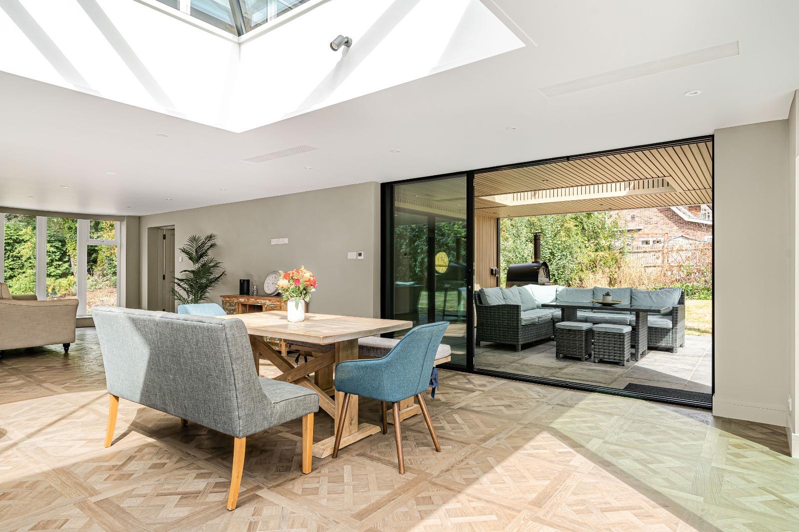 Versailles-style LVT continuing from the dining area towards the garden room